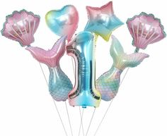 mermaid balloons in the shape of numbers one, two, three and four seashells