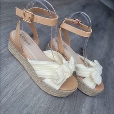 Beige/Cream Sandal With Satin Feel Bow Across Top Bamboo Brand Infinity Style. P/U Ankle Strap With Soft Fabric Bow Strap Across Foot. Perfect Sandals To Wear To All Your Spring Time Functions. Extremely Comfortable Sandal That’s Easily Wearable For All Ages. Tts Approx 1” Height Platform New In Box Beige Synthetic Wedge Sandals With Round Toe, Beige Synthetic Round Toe Wedge Sandals, Beige Synthetic Wedge Sandals For Beach Season, Adjustable Cream Platform Sandals, Trendy Adjustable Beige Wedge Sandals, Trendy Beige Adjustable Wedge Sandals, Casual Cream Platform Sandals, Cream Synthetic Wedge Sandals With Cushioned Footbed, Cream Wedge Sandals With Cushioned Footbed