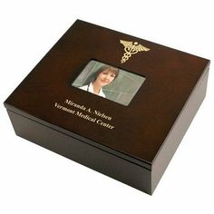 a wooden box with a medical symbol on the front and side, inlaid to an image of a woman's head