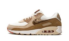 The Women’s Nike Air Max 90 “Snakeskin Swoosh” is a women’s-exclusive colorway of the classic running shoe that features earthy brown tones on its design.  As its name suggests, the “Snakeskin Swoosh” modifies the look of the Air Max 90 by swapping its original Swoosh logo with one made from an exotic brown snakeskin pattern.  A white mesh base forms the underlayer of the shoe while tan suede appears on the mid-panel and lower eyelets.  Elsewhere, a hairy brown suede mudguard matches the brown p Earthy Sneakers, Brown Nikes, Brown Nike Shoes, Brown Sneakers, Vintage Pants, Tan Suede, Jumpsuit Shorts Rompers, Designer Sandals, Aesthetic Shoes