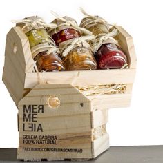 a wooden crate filled with jams on top of a table