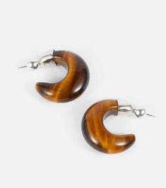 All Sophie Buhai's designs are made by local artisans in downtown Los Angeles. A retro design, the Donut hoop earrings are made from iridescent tiger’s eye encased in sterling silver for a beguiling addition to your fine jewelry repertoire..Material: 925 sterling silver.Stone I: tiger eye.Closure: post-back fastening.Made in the USA.For pierced ears.Length 25mm-1'.Max. width 10mm-0.4' Brown Hoop Single Earring, Modern Small Hoop Brown Earrings, Trendy Brown Hoop Jewelry, Brown Single Hoop Earring, Modern Brown Small Hoop Earrings, Modern Brown Round Jewelry, Trendy Nickel-free Brown Jewelry, Nickel-free Brown Hoop Jewelry, Modern Brown Nickel-free Jewelry