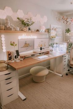 a home office with lots of plants on the wall and desks in front of it