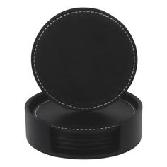 a black leather coaster with white stitching on the edges and an inner ring in the middle