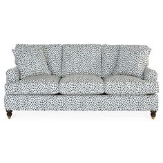 a black and white couch with polka dot print on the back, in front of a white background