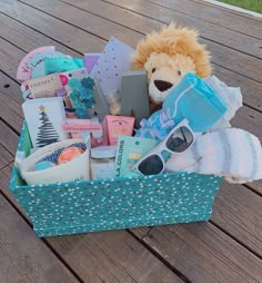 a stuffed animal is sitting in a basket filled with personal care items on a wooden deck