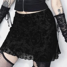 This Gothic Pattern Mesh Overlay Mini Skirt exudes alternative aesthetics with a touch of sophistication. The intricate Gothic pattern mesh overlay adds texture and depth, while the lettuce hem and above-the-knee length create a flattering silhouette. Crafted from a luxurious blend of polyester and spandex, this skirt offers both comfort and style, making it a must-have for those who embrace a bold and edgy look. Spring Mesh Mini Skirt, Sheer Mesh Mini Skirt, Mesh Mini Skirt For Spring, Gothic Flowy Skirt, Gothic Lined Skirted Bottoms, Gothic Mini Skirt For Spring, Gothic Lined Mini Skirt For Spring, Spring Gothic Mini Skirt, Fitted Mesh Mini Skirt