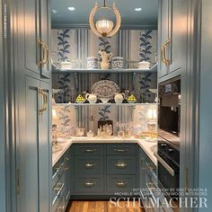 a kitchen with blue cabinets and white counter tops