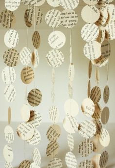 some paper hearts hanging from strings with words on them and string attached to the strings