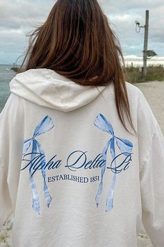 Product Color Vanilla Ice Product Description Elevate your sorority wardrobe with our Vanilla Ice Alpha Delta Pi Bow Matching Set Light Weight Hoodie. Crafted from the softest French terry fabric, this hoodie provides ultimate comfort and style, making it a staple year round. Embrace the perfect blend of warmth and breathability with this must-have addition to your collection Note: This product is designed for a comfortable and breathable fit. It is intentionally crafted as a lightweight option, Sorority Hoodie Design, Sorority Instagram Stories, Alpha Delta Pi Merch, Alpha Phi Shirts, Coquette Design, Sorority Events