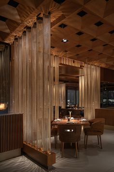 a dining room with wooden walls and tables in the center is lit by lights that are hanging from the ceiling