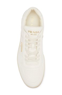 A monochrome palette lends clean minimalism to a lambskin-leather low-top sneaker featuring a perforated toe and three versions of the iconic Prada logo. Lace-up style Removable insole Leather upper and lining/rubber sole Made in Italy Designer Shoes Classic Calf Leather Sneakers With Logo, Modern Low-top Sneakers With Logo Plaque, Luxury White Sneakers With Logo Plaque, Modern Calf Leather Sneakers With Logo Plaque, White Sneakers With Logo Plaque For Streetwear, Modern White Sneakers With Logo Plaque, Modern Calf Leather Sneakers With Logo, Luxury Calf Leather Sneakers With Perforations, Luxury Perforated Calf Leather Sneakers