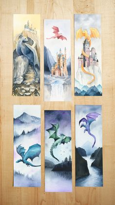 four dragon paintings are displayed on a wooden surface