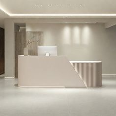 an empty lobby with a white reception counter