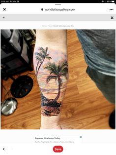 a man's arm with a palm tree and beach scene tattoo on the forearm