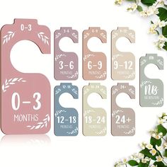 six baby bibs with numbers on them and flowers in front of the image, including one