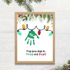 a christmas card with the words merry and bright on it, hanging from a pine tree