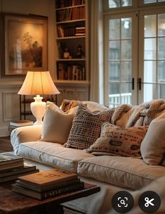 a living room filled with lots of furniture and a lamp on top of a table