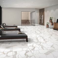 a living room with white marble floors and furniture