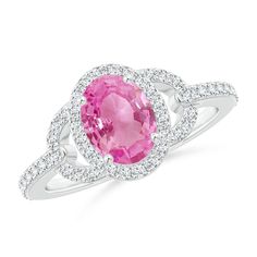 Blossomy and enchanting, the prong set oval pink sapphire is illuminated by a sparkling diamond halo and curved segments on the shoulders. Additional diamond accents are pave set on the shank and enhance the luxurious elegance of this oval pink sapphire ring with halo in 14k white gold. Ring With Halo, Sapphire Halo Ring, Vintage Sapphire Ring, September Birthstone Jewelry, Pink Sapphire Ring, Sparkling Diamond, Rings For Girls, Halo Diamond Ring, Pink Ring