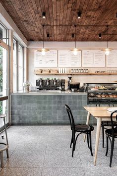 the interior of a coffee shop with tables and chairs