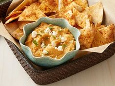 a basket filled with tortilla chips and dip