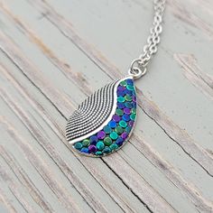 This cute necklace would make a great gift. It has been hand painted in peacock colors with purple, green, blue, and teal dots.  The chain is a silver color stainless steel. The charm measures 1 1/4" tall. *Choose the length of the necklace. This would make a great gift for a birthday, an anniversary, Christmas or any other occasion. All jewelry items come in a gift box. Colors With Purple, Peacock Colors, Dot Necklace, Wood Guest Book, Hand Painted Gifts, Memory Locket, Cute Necklace, Purple Green, Locket