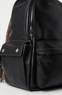 Manufacturing of the grained calfskin enriches the texture with slightly uneven coloring, giving the look of the leather a “vintage” flavor. On the inside, the accessory is lined in water-resistant fabric to protect its contents from the light contact with liquids. Zip closure Adjustable shoulder straps Handle Outside zipper pocket Side pockets with magnetic snaps Water-resistant fabric lining Internal compartment with zipper 3 open internal compartments Strap on back for attaching to trolley ha Blazer And T Shirt, Mens Eyewear, Eyewear Womens, Boutique Online, Womens Fragrances, Water Resistant Fabric, Mens Fragrance, Women Fragrance, Black Backpack