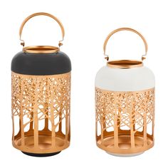 two white and gold lanterns with trees on the front, one black and one white