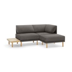 a gray couch with wooden legs and a coffee table in front of it on a white background