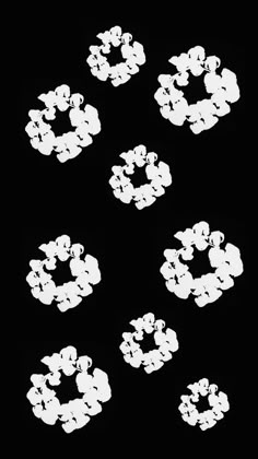 six white circles are arranged in the shape of flowers