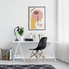 a white desk with a black chair in front of it and a painting on the wall