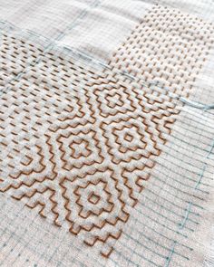 a close up view of the fabric on a tablecloth with brown and white designs