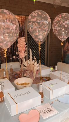 the table is set up for a party with balloons and confetti on it