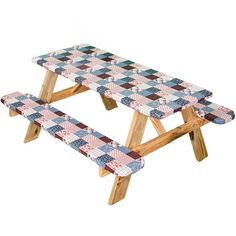 a picnic table made out of wood with a checkerboard pattern on the top