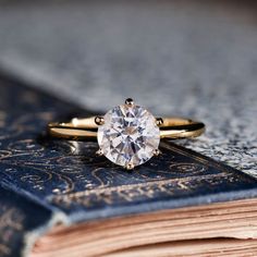 a close up of a ring on top of a book