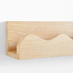 a wooden shelf with two compartments on it