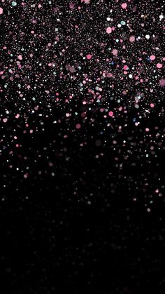 pink and blue confetti sprinkles are falling from the dark sky