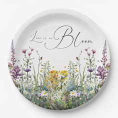 a white plate with flowers on it that says, love is a blemm