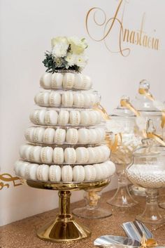 there is a wedding cake made out of shells on the table next to other desserts