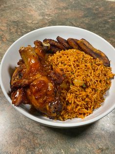 a white plate topped with meat and rice