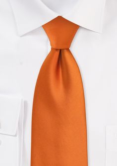 One of our most popular neckties for the groom and groomsmen at a summer or spring wedding is this "persimmon" orange necktie. The vivid orange hue emits outstanding luster. On a sunny day, it is the ideal complement to a joyous celebration. This tie works just as well with professional clothing as it does with wedding attire. It is a stylish necktie that will make any business attire more enjoyable to wear while still projecting a professional image. Peach Apricot Solid Necktie Elegant Orange Suit And Tie Accessories For Formal Occasions, Orange Formal Suit And Tie Accessories, Elegant Orange Tie For Business, Classic Orange Ties For Business, Orange Standard Tie For Business, Classic Orange Tie For Business, Orange Standard Business Tie, Orange Business Tie, Business Attire For Men