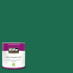 a can of behr paint on a teal green background with the words behr written