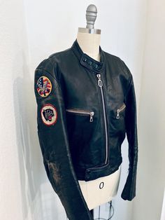 Vintage 1970s BAD GIRL Black Leather Biker Jacket w/super cool patches! Distressed Classic Moto Style Made by "Harro Kombi" - made in Germany 100% leather, distressed  Size M (medium) Chest:  36" Sleeve:  24.5" Length:  23.5" Shoulder to shoulder: 18" Condition: All zips & poppers in perfect working condition COOL DISTRESSED CONDITION Vintage Leather Motorcycle Jacket With Long Sleeves, Vintage Leather Jacket For Motorcycling, Retro Fitted Biker Jacket With Long Sleeves, Retro Fitted Long Sleeve Biker Jacket, Fitted Cafe Racer Biker Jacket For Motorcycling, Vintage Long Sleeve Motorcycle Outerwear, Vintage Outerwear For Motorcycling In Fall, Vintage Fall Outerwear For Motorcycling, Vintage Fall Motorcycling Outerwear