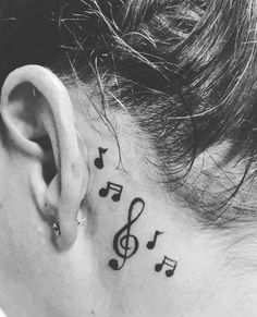 a woman's ear with musical notes on it