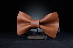 ✨Be stylish and unique with a Genuine Leather Bow Tie! ✨ It's a great accessory for wedding or any other special occasion. This item will give you confidence during all event, you will no longer be worried about your appearance, because  wearing this bow tie you will look just perfectly 🎀MATERIALS: Our Bow ties are made of 100% Full Grain Leather made in Italy.  100% Handmade accesories. Minimalist design, unisex. 🎀SIZE: - 6x11 cm. (2.3x4.3") - strap is regulated; - the width of strap is 1.5 c Classic Detachable Bow As A Gift, Classic Brown Suit And Tie Accessories As Gift, Adjustable Detachable Bow Tie As Gift, Father's Day Gift Bow Tie And Suit Accessories, Dapper Bow Tie With Detachable Bow As Gift, Dapper Detachable Bow Tie As Gift, Classic Bow Tie For Suit Accessories As Gift, Classic Ties With Bow Tie Back For Gifts, Dapper Brown Bow Tie For Wedding