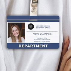 a person holding a id card with the name of an employee on it, in front of a white background