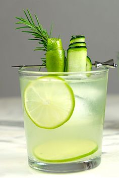 two glasses filled with limeade and cucumbers