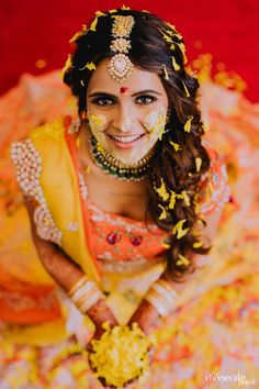 a woman in yellow and gold is posing for the camera