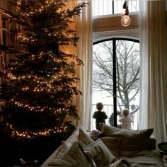 a living room with a christmas tree in the corner